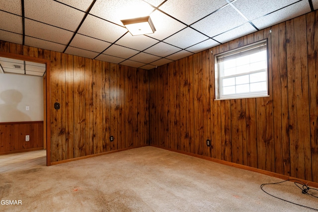 basement with light carpet and wooden walls