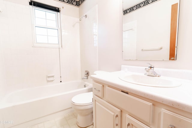 full bathroom featuring tiled shower / bath combo, toilet, and vanity