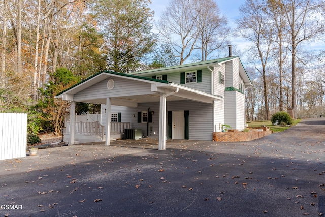 view of property featuring a carport and central AC