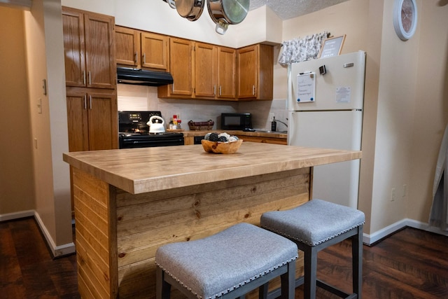 kitchen with wood counters, tasteful backsplash, dark hardwood / wood-style floors, a kitchen bar, and black appliances