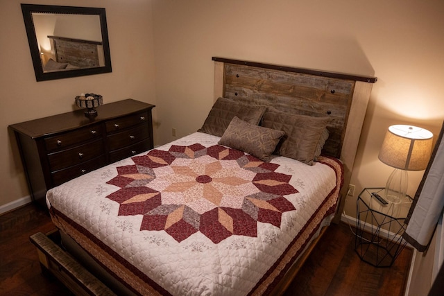 bedroom with dark wood-type flooring