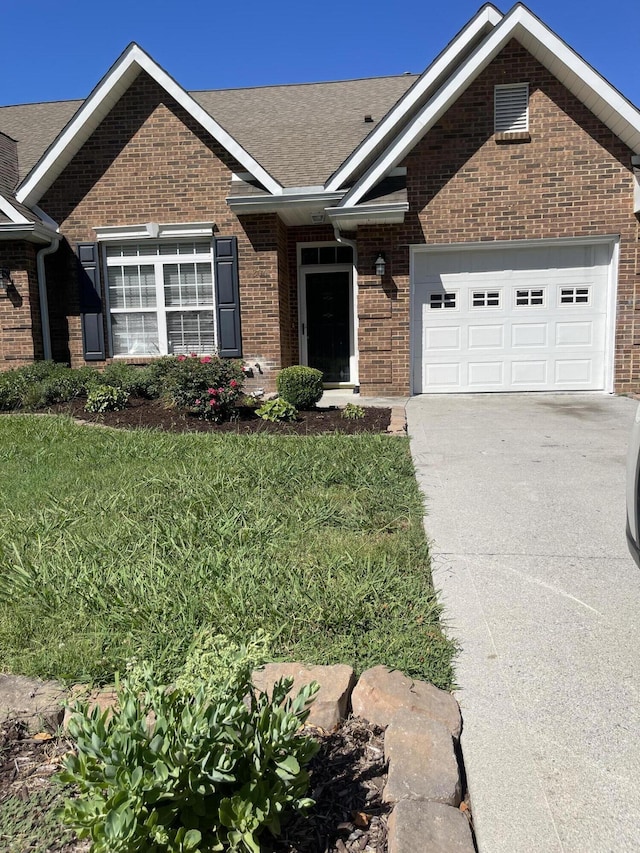 view of front of house featuring a front yard and a garage