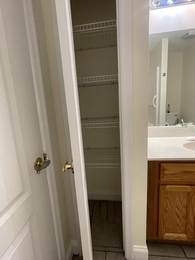 bathroom with tile patterned flooring and vanity