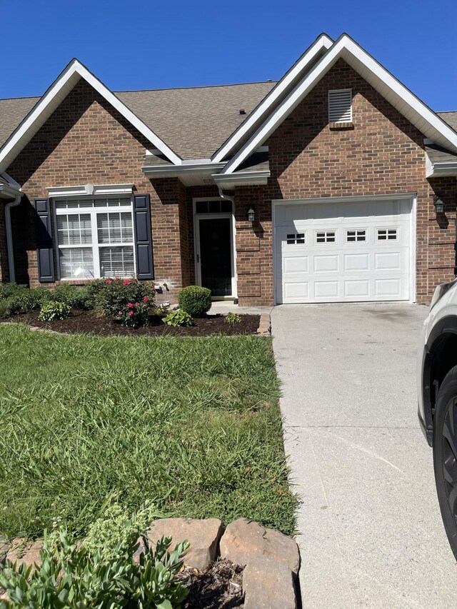 view of front facade with a front yard and a garage