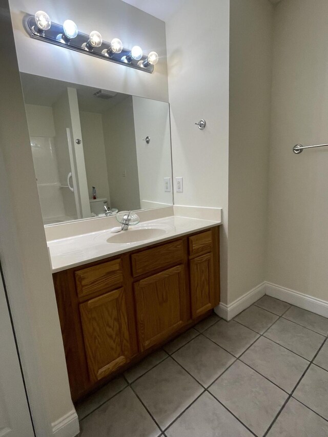 bathroom with tile patterned floors and vanity