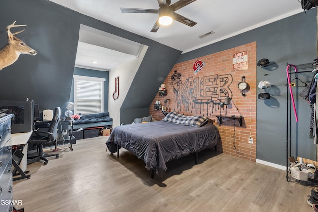 bedroom featuring wood finished floors, ceiling fan, and visible vents
