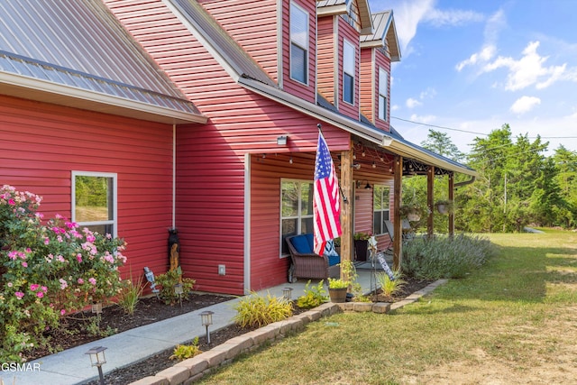 doorway to property with a lawn