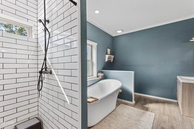 full bath with a tile shower, a soaking tub, wood finished floors, and recessed lighting