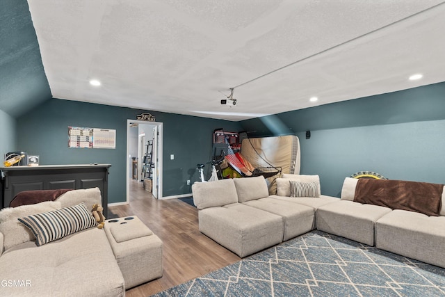 living room with wood finished floors, baseboards, vaulted ceiling, and recessed lighting