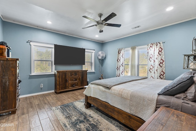 bedroom featuring recessed lighting, visible vents, crown molding, and wood finished floors