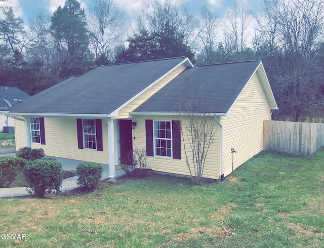 ranch-style house with a front lawn and fence