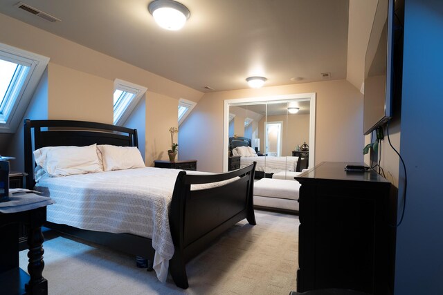 bedroom featuring visible vents, carpet, and a skylight