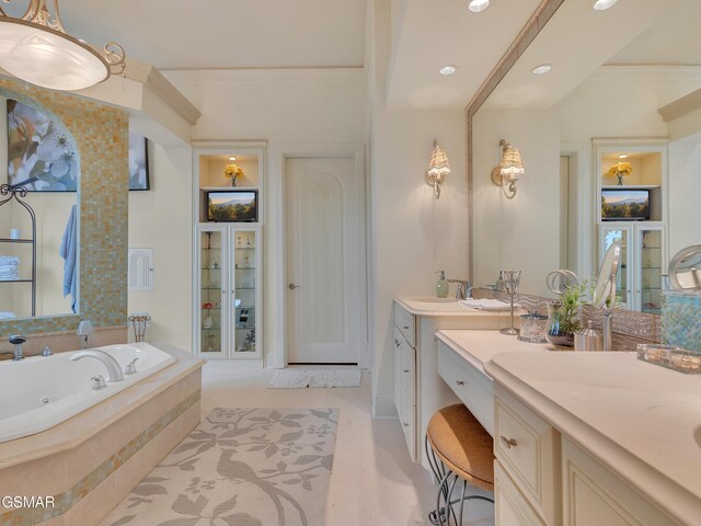 bathroom with a whirlpool tub, recessed lighting, built in shelves, and vanity