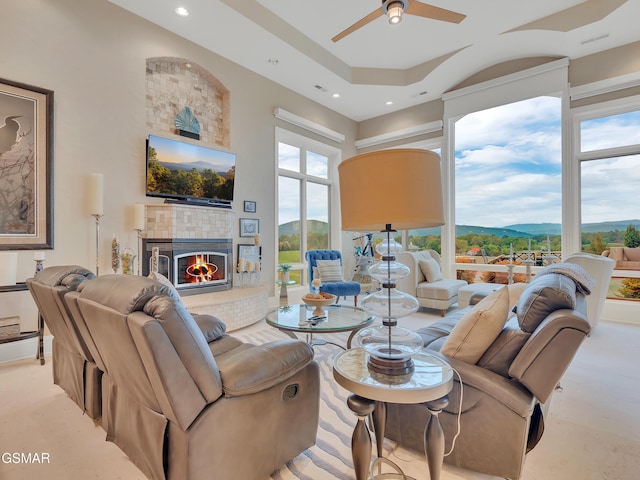 living room featuring recessed lighting, a ceiling fan, visible vents, and a fireplace