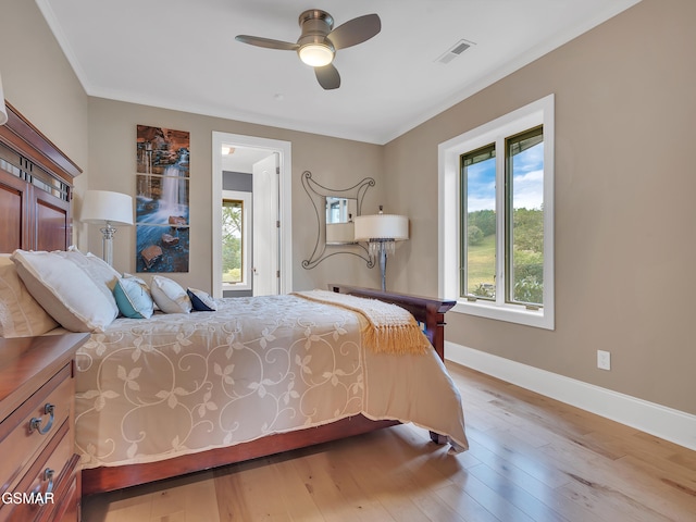 bedroom featuring baseboards, visible vents, ceiling fan, and hardwood / wood-style floors
