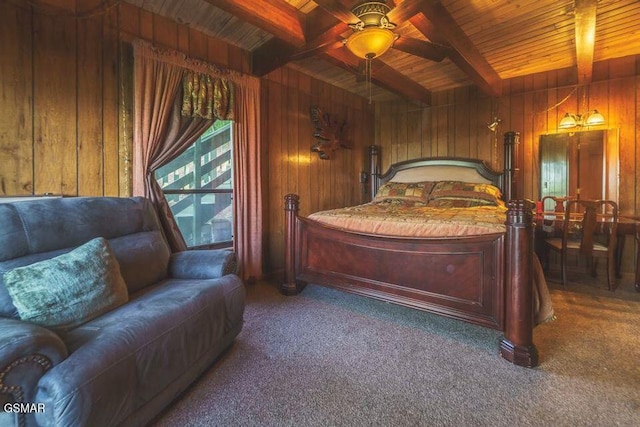 carpeted bedroom with beam ceiling, wood ceiling, and wood walls