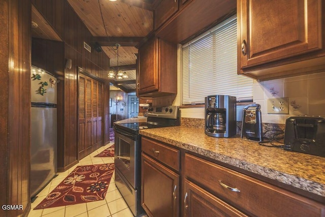 kitchen with light tile patterned floors, wooden ceiling, stainless steel appliances, and dark countertops