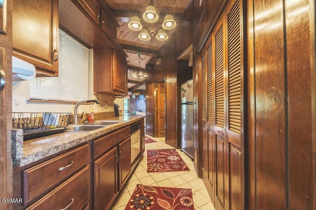 kitchen with light tile patterned floors, beam ceiling, wooden ceiling, freestanding refrigerator, and a sink