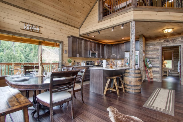 dining area featuring high vaulted ceiling, dark wood-style flooring, rustic walls, and wood ceiling