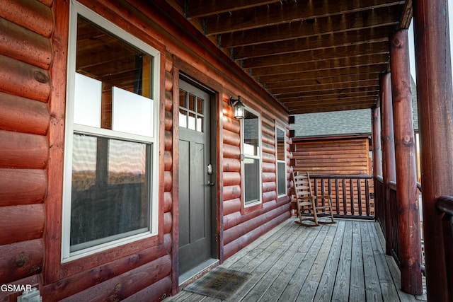 wooden terrace featuring covered porch