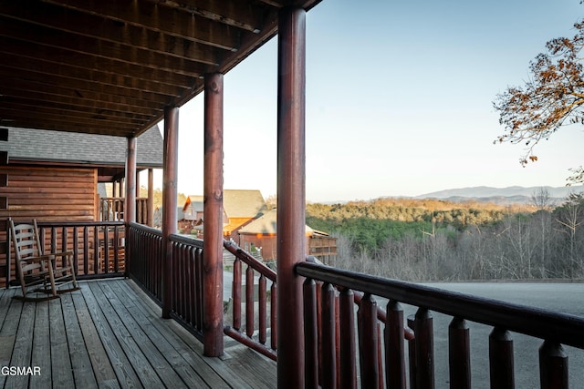 deck featuring a mountain view and a forest view