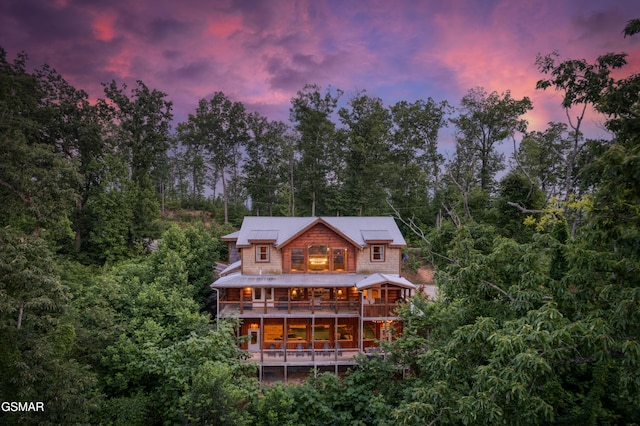 809 Pinecrest Way, Sevierville, TN 37862 - back of house at dusk featuring metal roof and a balcony