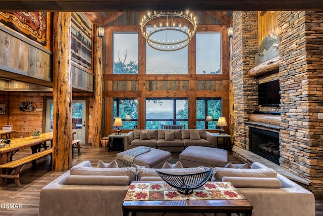 809 Pinecrest Way, Sevierville, TN 37862 - living area with a towering ceiling, wood finished floors, a chandelier, a fireplace, and wooden walls