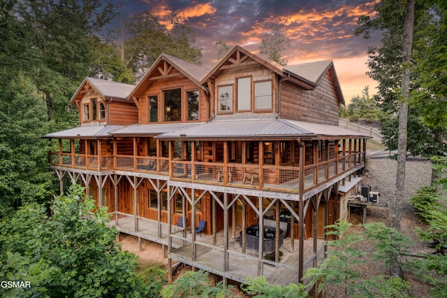 809 Pinecrest Way, Sevierville, TN 37862 - rear view of house with metal roof, a jacuzzi, and a wooden deck
