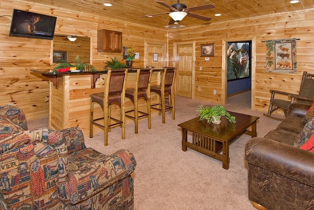 living room featuring light colored carpet, ceiling fan, and wood ceiling