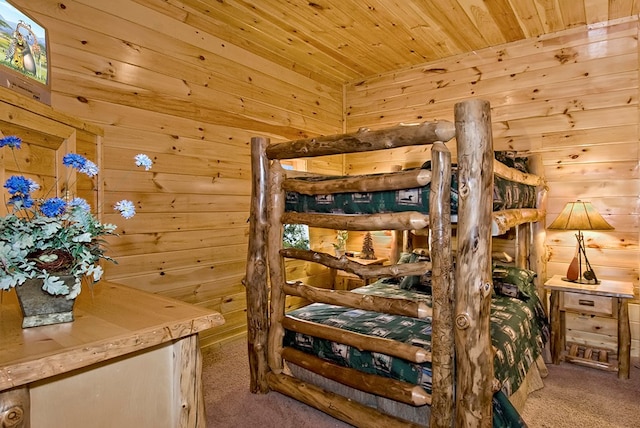 carpeted bedroom featuring wood walls and wood ceiling