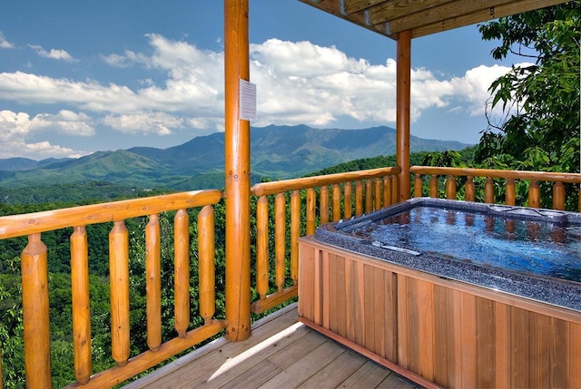 deck featuring a mountain view and a hot tub