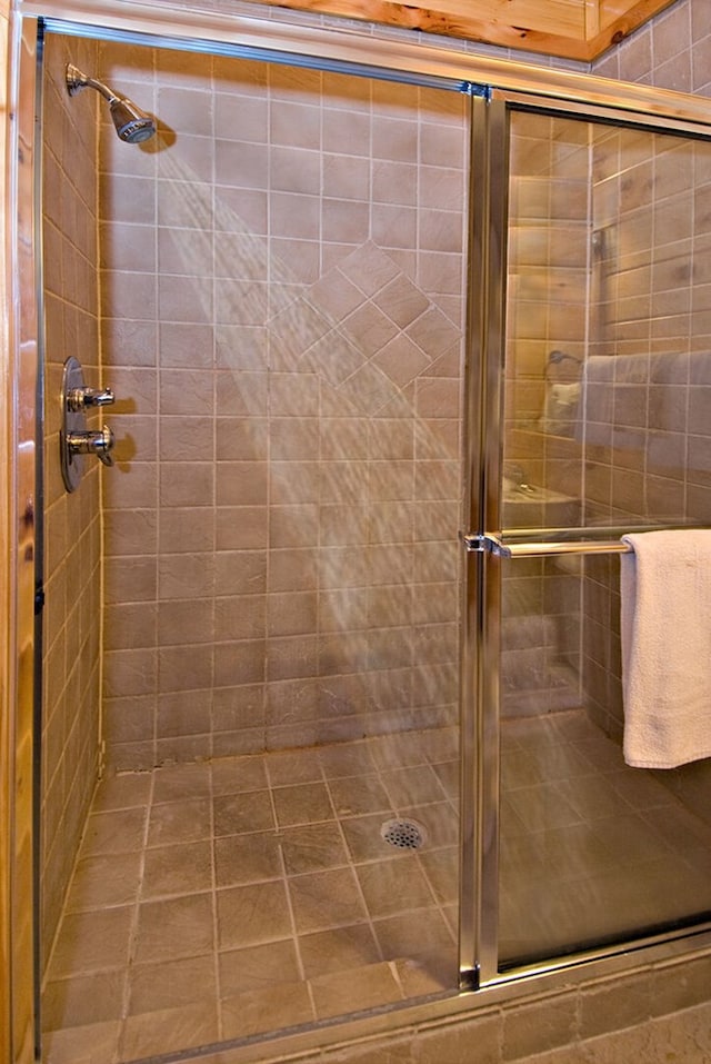 bathroom with a shower with door