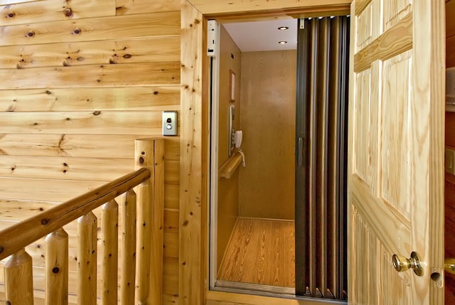 interior space featuring wooden walls and elevator