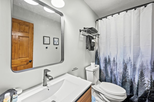 bathroom featuring vanity, a shower with shower curtain, a textured ceiling, and toilet