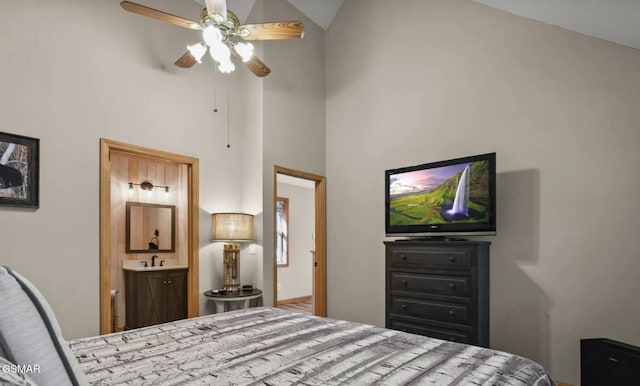 bedroom featuring high vaulted ceiling, ensuite bath, and a ceiling fan