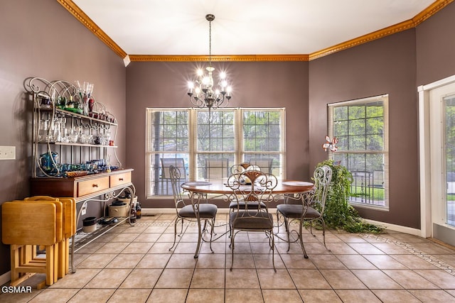 dining room featuring crown molding, light tile patterned floors, baseboards, and an inviting chandelier
