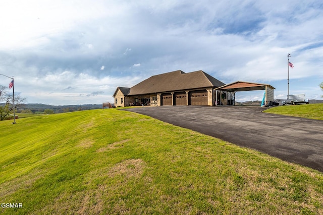 view of front of house featuring a garage, a front yard, and driveway