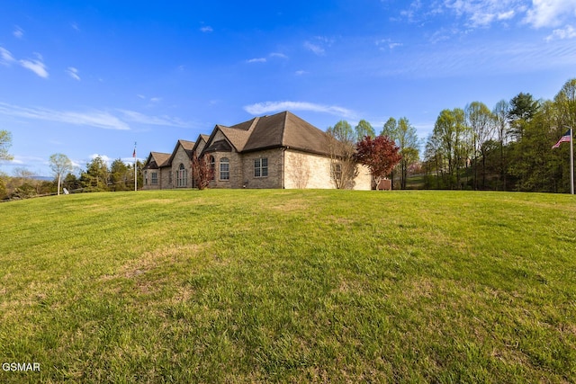 view of side of home with a yard