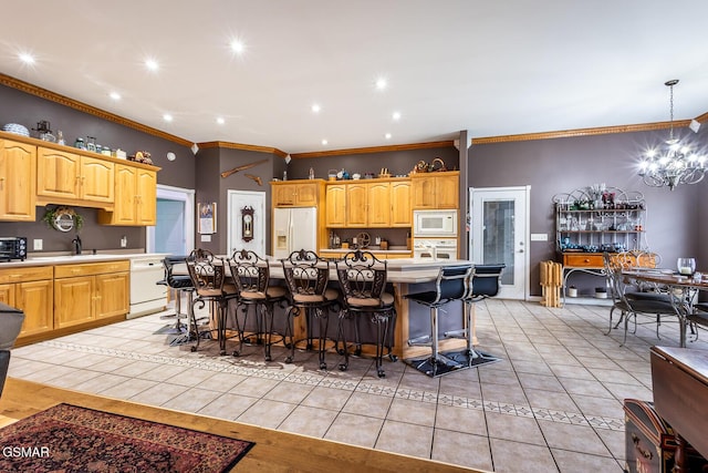 kitchen featuring crown molding, light countertops, white appliances, and light tile patterned flooring