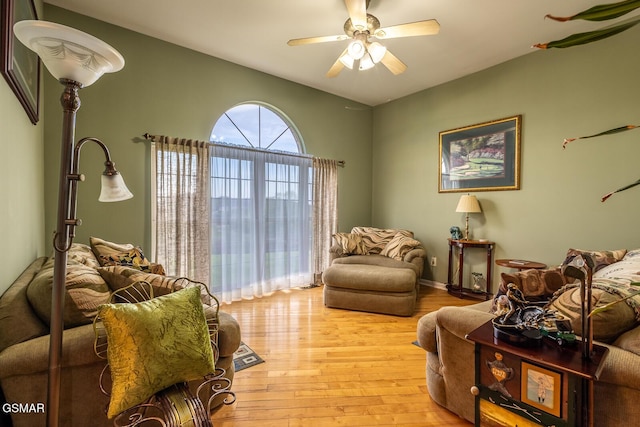 living area featuring light wood-style flooring and a ceiling fan