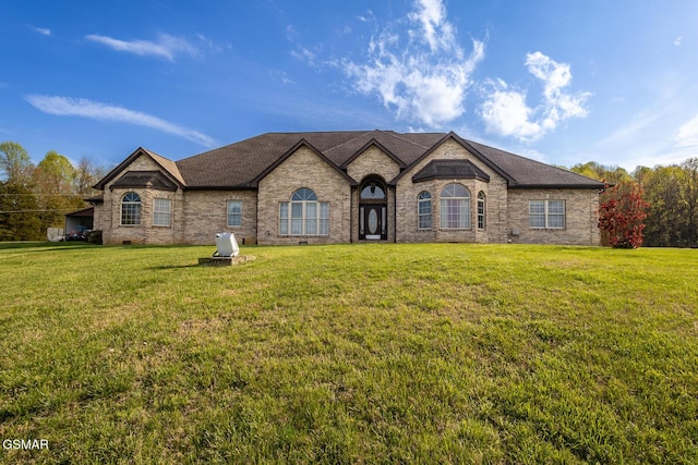 view of front of home featuring a front yard and brick siding