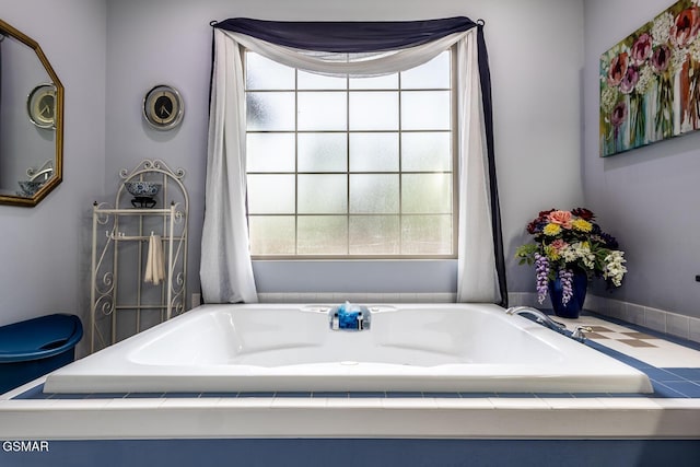 full bath featuring plenty of natural light and a garden tub