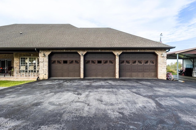 garage featuring aphalt driveway