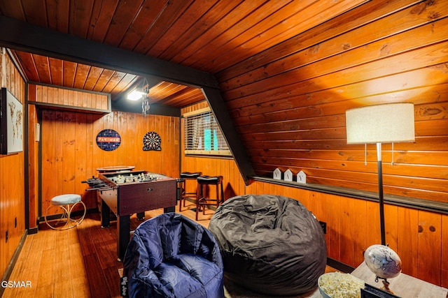 game room featuring wooden ceiling, wood walls, hardwood / wood-style flooring, and beam ceiling