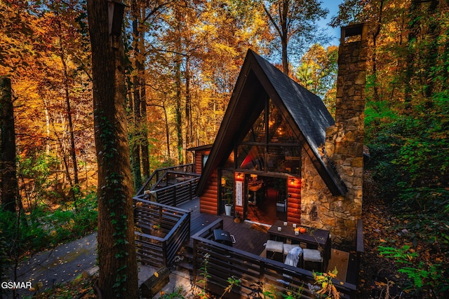 exterior space with faux log siding and a wooden deck