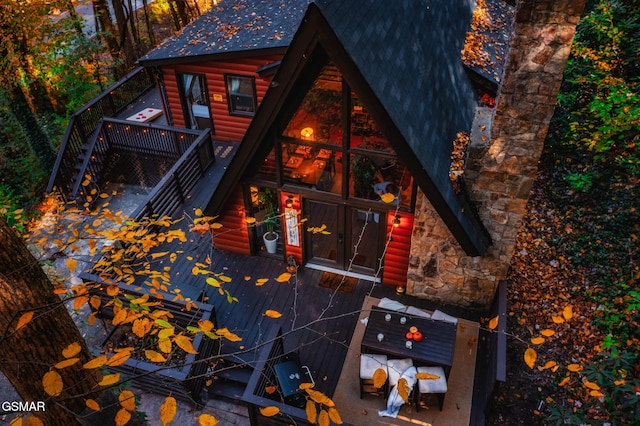 exterior space with a wooden deck and log veneer siding