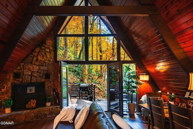 living area featuring wood ceiling, lofted ceiling with beams, and hardwood / wood-style flooring