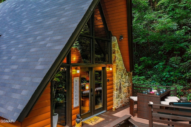 view of property exterior featuring a wooden deck and stone siding