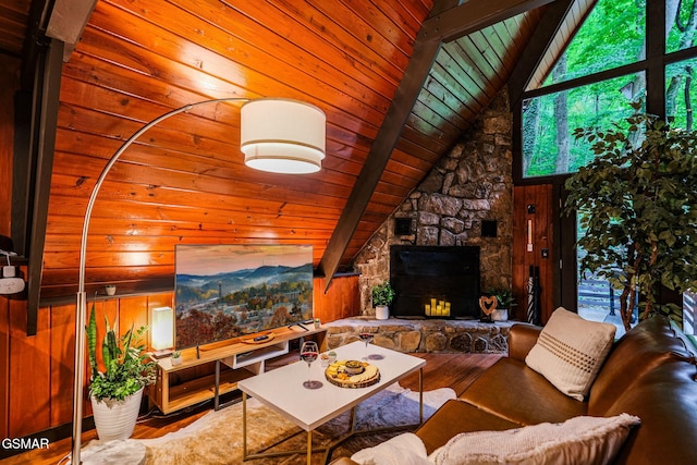 living area with wood walls, wood finished floors, lofted ceiling with beams, and wood ceiling