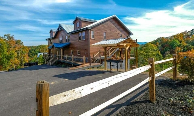 exterior space featuring a deck and metal roof